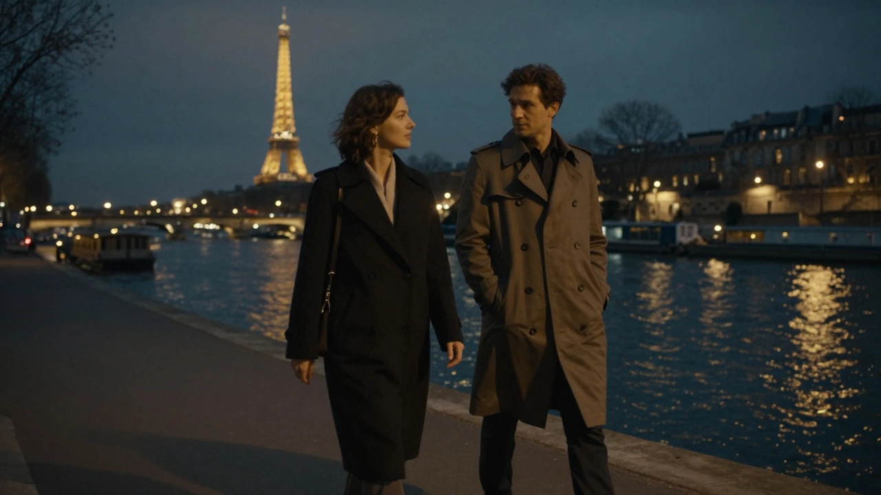 A woman and man walking silently along the Seine at night in Paris.